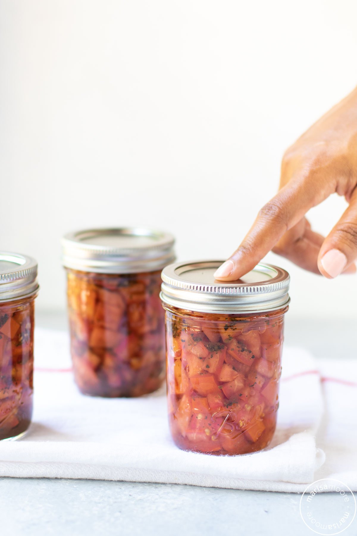 pressing the top of a jar with an index finger