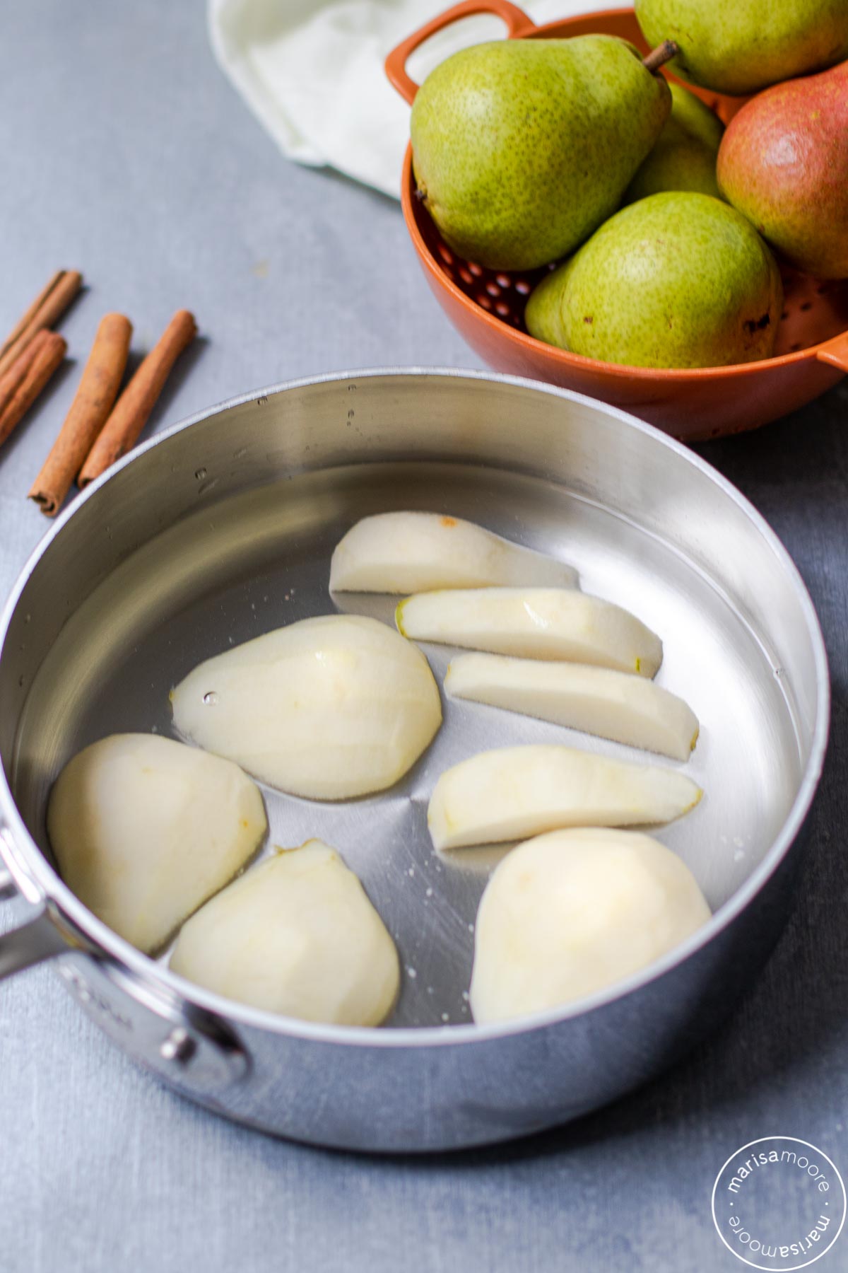 cut pears in water in a pan