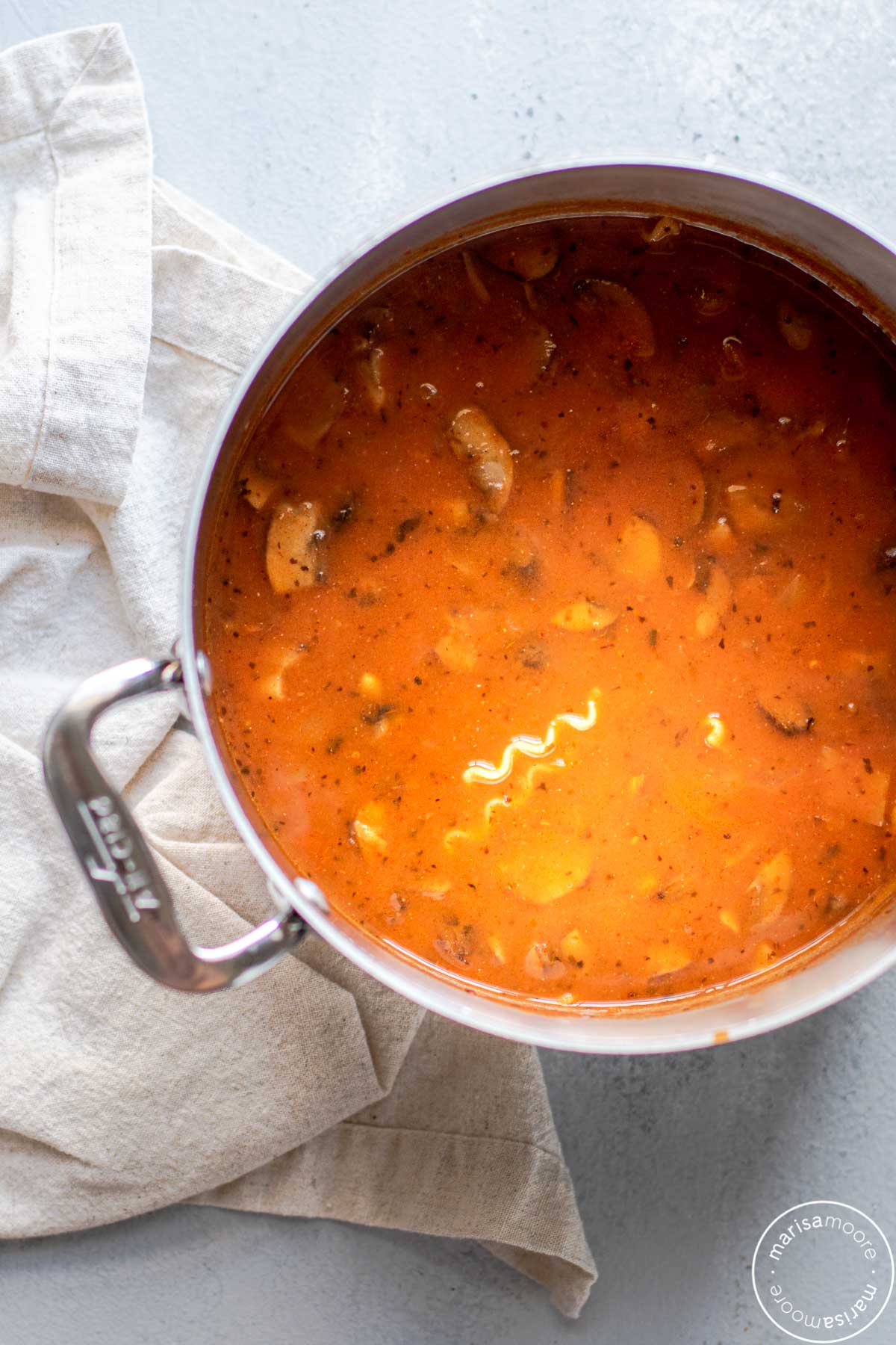 Pot of lasagna soup with a beige cloth napkin on the side