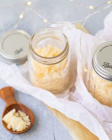 sugar cookie scrub in small jar with lights in background