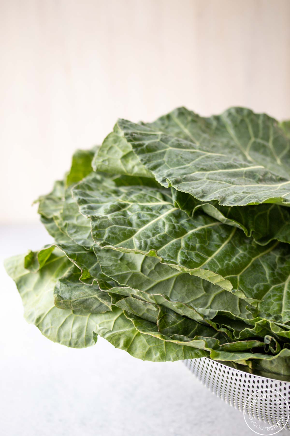 clean collard greens in a colander