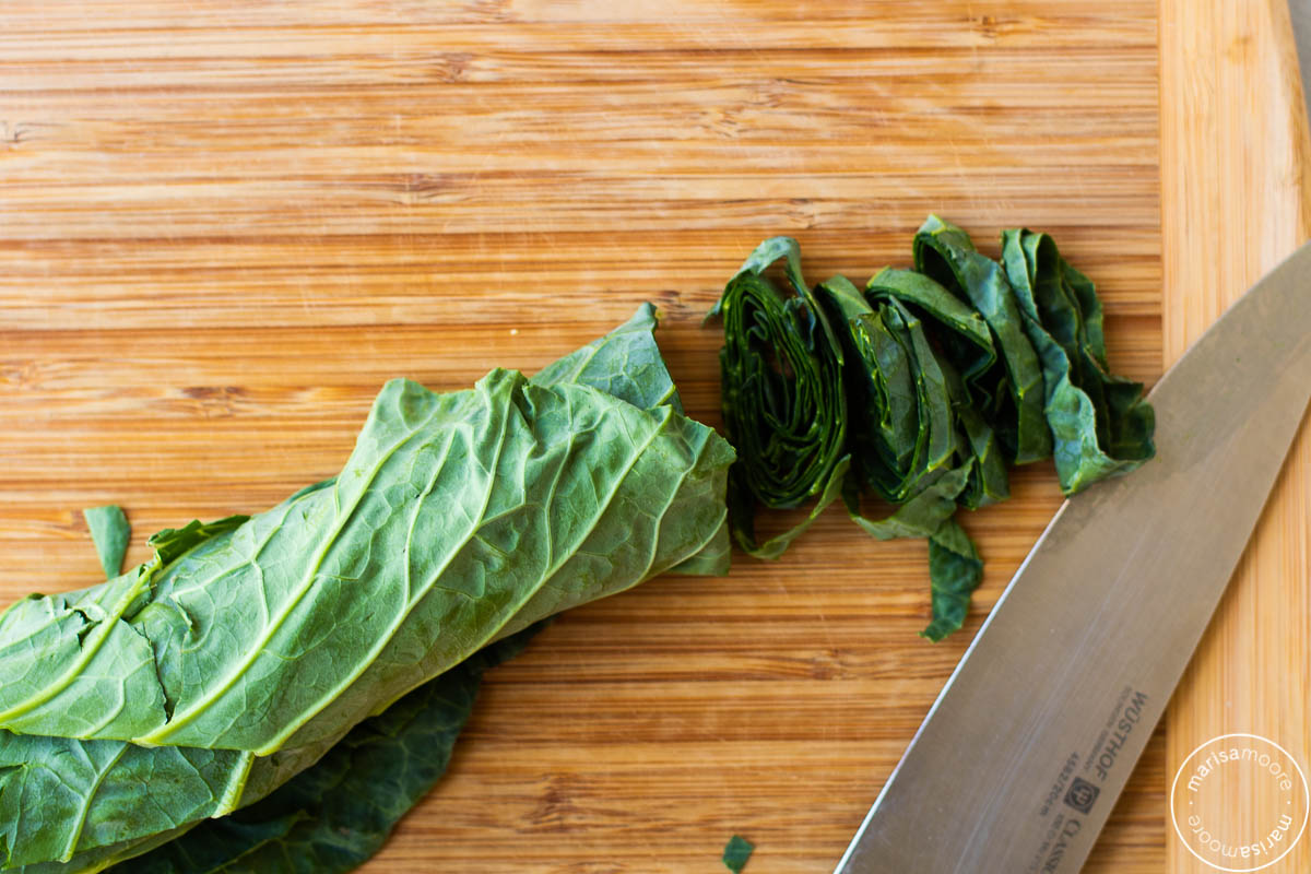 Rolled collard greens being chopped