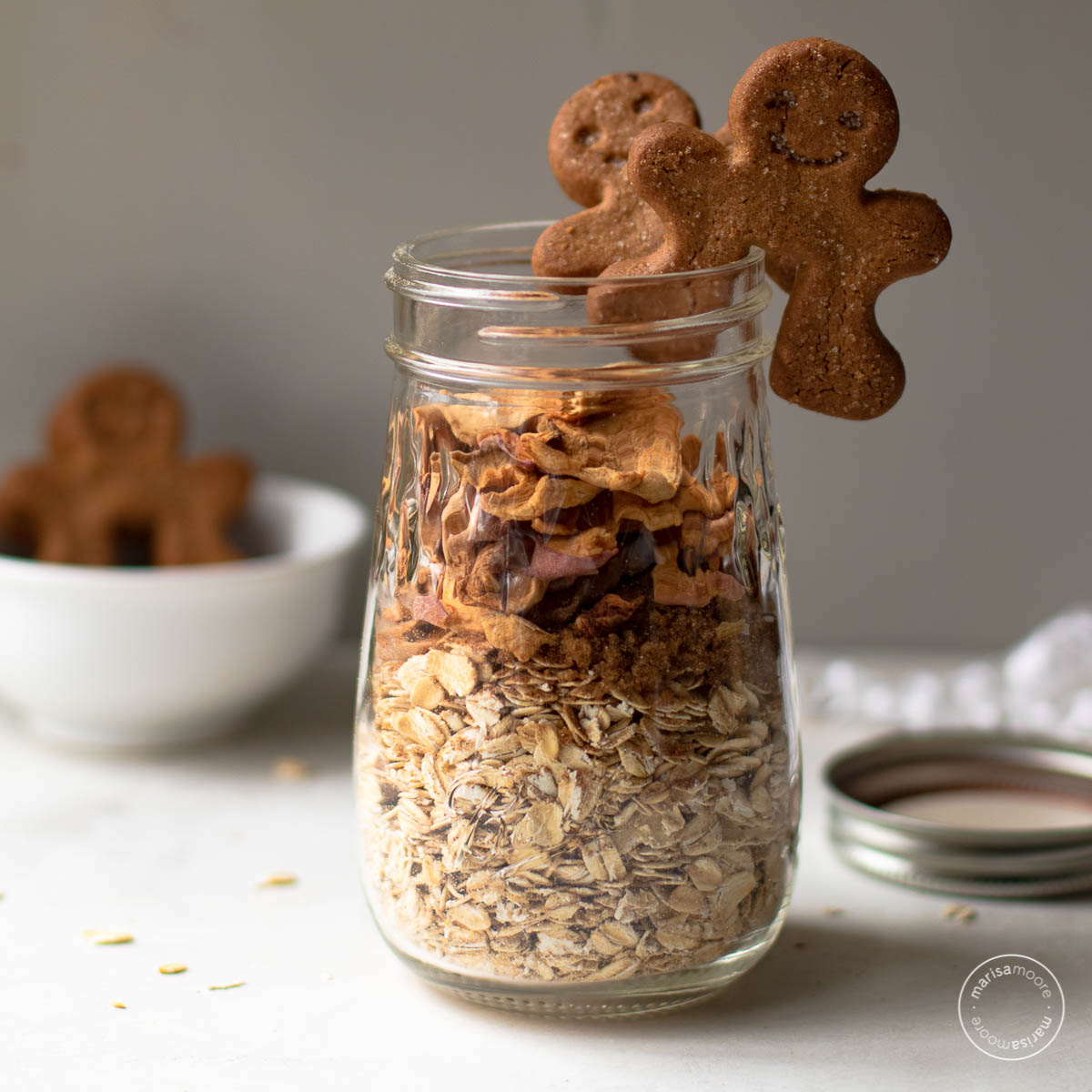 Overnight oats in a jar with two gingerbread cookies on top