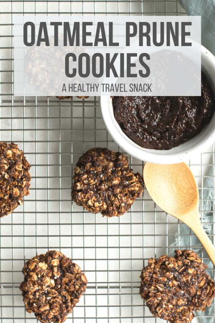 Cookies on a cooling grate with a bowl of prune puree and a spoon.