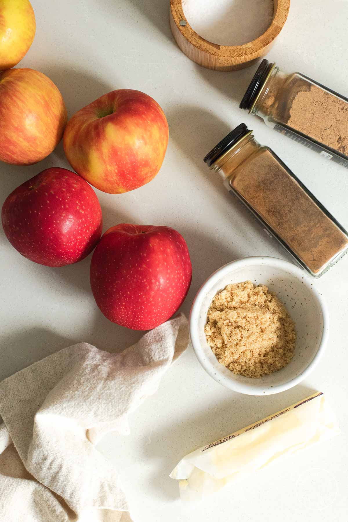 Apples, spice bottles and brown sugar